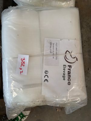 two bags of white pillows sitting on top of a wooden floor