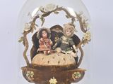 a glass dome with a figurine inside of it