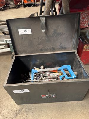 a metal tool box with tools in it on the floor