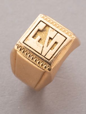 an image of a gold signet ring with the letter e on it