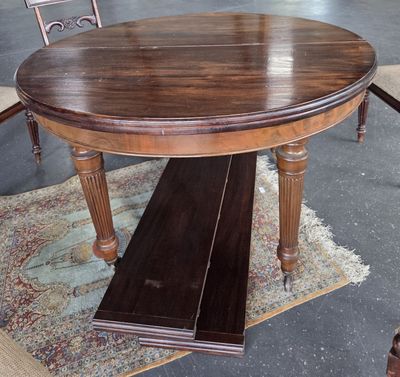 a wooden table with a bench on it in the middle of a room