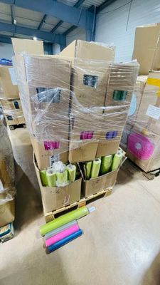 many boxes of toilet paper on the floor in the warehouse
