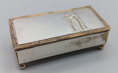 an antique silver box with a picture of a man and woman on it