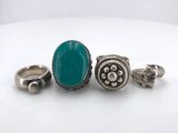 three rings and a ring with a turquoise stone on it
