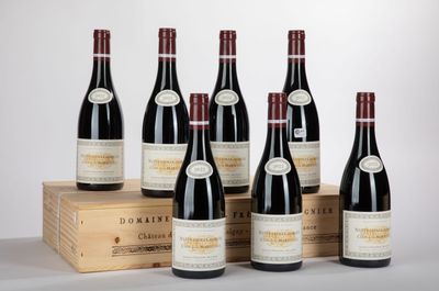 six bottles of red wine sit in front of a wooden box