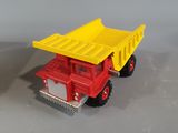 yellow and red toy dump truck sitting next to each other on a gray surface