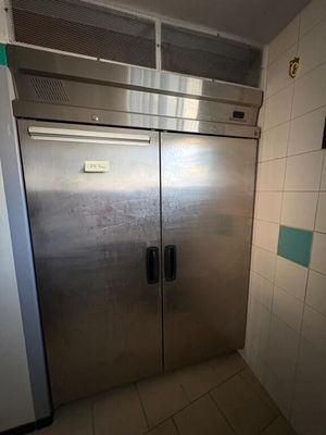 stainless steel double door freezer in a kitchen with tiled walls