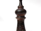 a wooden vase that is sitting on a white surface