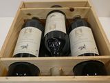 three bottles of wine in a wooden box