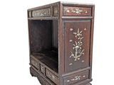 a small wooden cabinet with a floral design on it