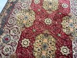 a red rug on the floor in a room
