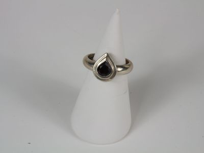 a close up of a silver ring with a black stone on it