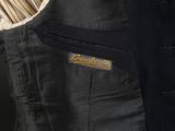 an image of a black jacket with a striped shirt underneath it