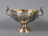 a silver bowl that is sitting on a table
