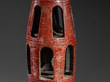 a red vase that is sitting on a table