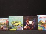 several children ' s books are lined up on a black surface