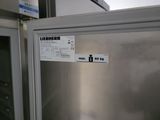 a silver refrigerator with a sticker on the side of it