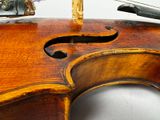 a close up of a violin with a violin case on the back of it