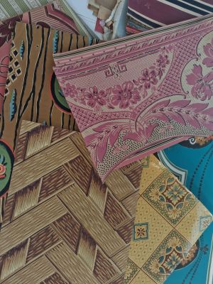 many different patterns and colors of fabric on a table