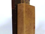 two books sitting on top of each other on a white surface