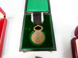 a small box with a medal on it next to other items