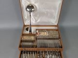 a wooden box with silverware in it on a table