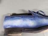 a pair of blue shoes that are sitting on a table