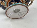 a blue and gold tea pot with a lid