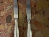 two knives that are sitting on a table