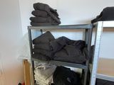 a metal shelving filled with lots of clothes