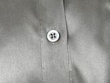 a close up of a shirt with a button on it