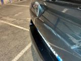 a close up of a car ' s front bumper with a sticker on it