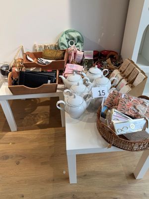 une table blanche sur laquelle se trouve un panier contenant des tasses à thé et à café