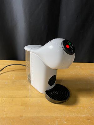 a coffee maker that is sitting on a wooden table