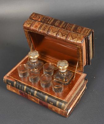 four glasses in a wooden box on a table