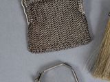 a small silver purse with a brush and a mirror