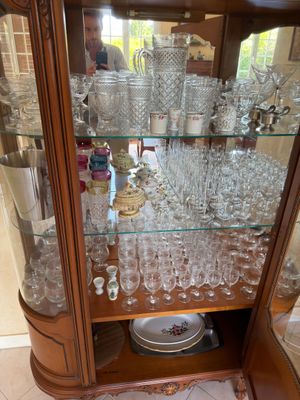 a glass display case with a lot of wine glasses on it