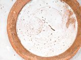 a brown bowl with a white substance in it