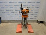 the machine is sitting on the floor in front of the wall