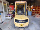 a yellow forklift truck parked in a garage