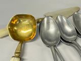 five spoons and a spatula sitting on a table