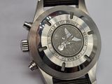 a close up of a watch on a white surface
