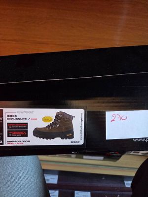 someone is holding a box with a pair of hiking boots on it