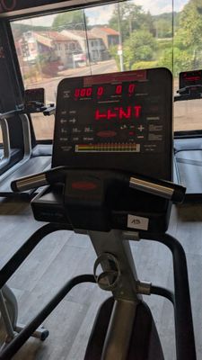 a view of a gym room with treads and a monitor