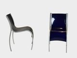 two chairs sitting next to each other on a white surface