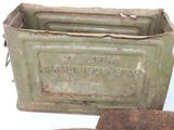 an old metal box with a sign on it next to other items