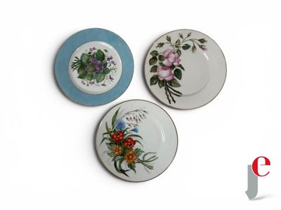 three plates with different designs on them on a white surface