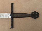 a knife that is laying on a brown surface