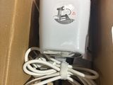 a box with a charger inside of it on a table