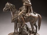 bronze statue of a man on a horse with a woman on a horse